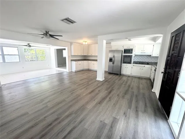 wooden floor in an empty room with a window