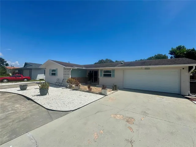 a backyard of a house with table and chairs