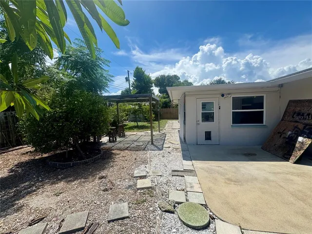 a view of a backyard with plants and a patio