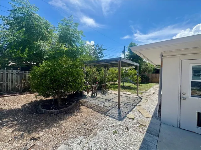 a view of a backyard with sitting area and furniture