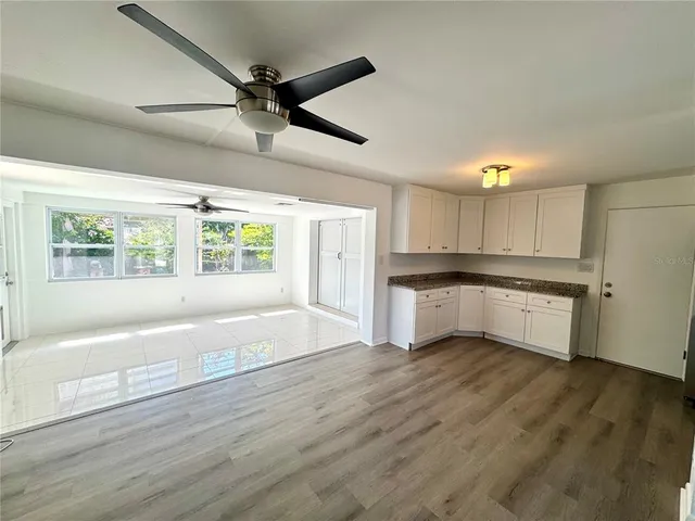 a large kitchen with a large window appliances and cabinets
