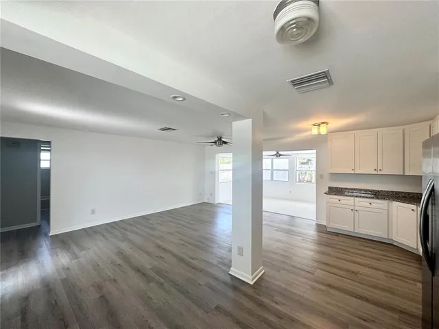 a view of a kitchen with wooden floor