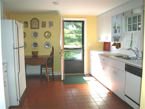 115 Moore Road Sudbury, MA 01776 - Photo 5 of 12 a kitchen with stainless steel appliances granite countertop a refrigerator and a sink