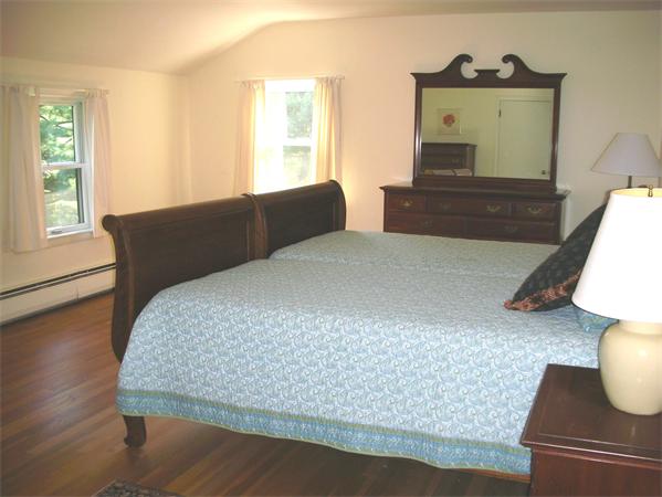 115 Moore Road Sudbury, MA 01776 - Photo 7 of 12 a bedroom with a bed and wooden floor