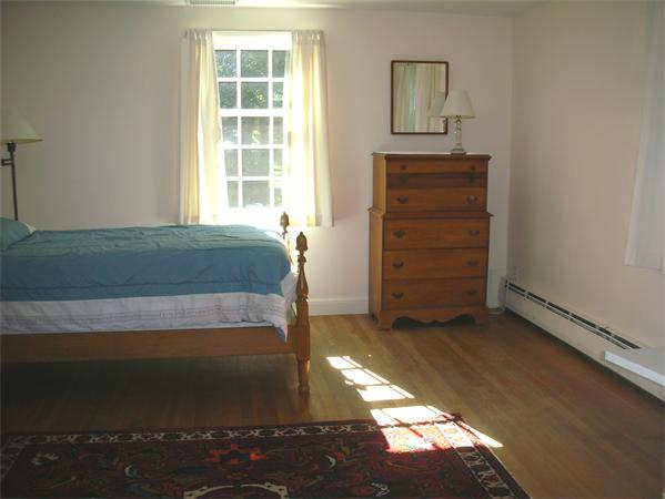 115 Moore Road Sudbury, MA 01776 - Photo 8 of 12 a bedroom with a bed and a window