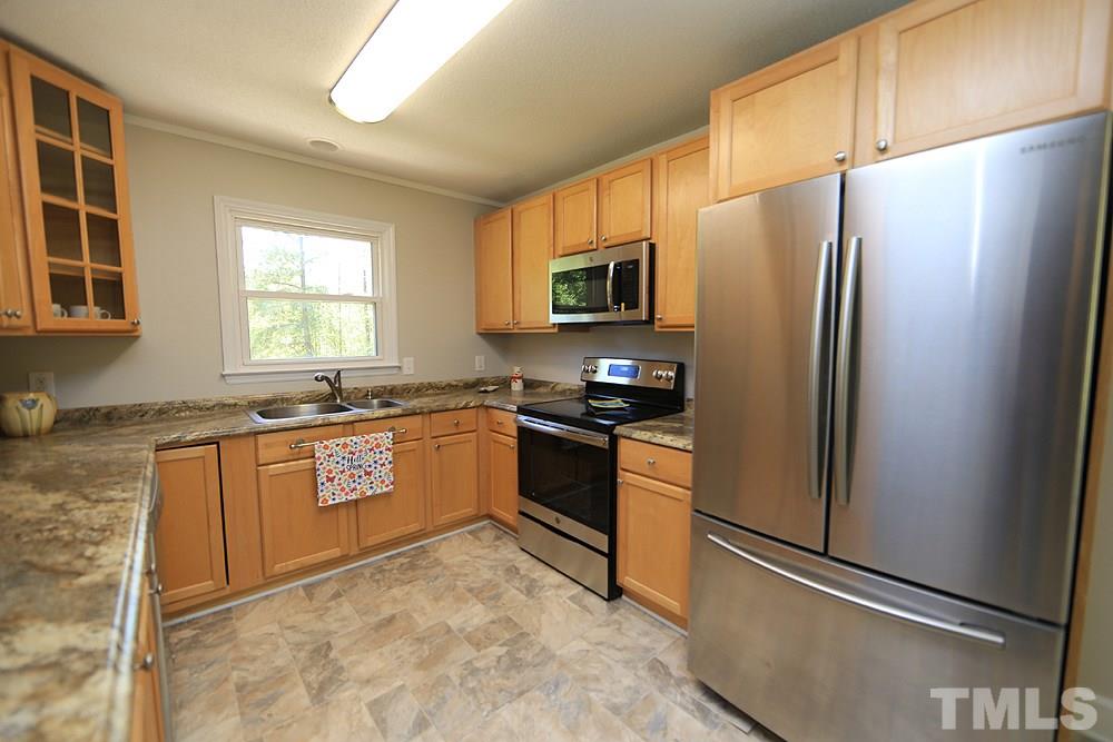 3312 High Gate Road Raleigh, NC 27603 - Photo 2 of 22 a kitchen with granite countertop a refrigerator and a sink