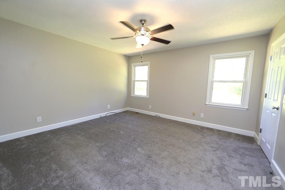 3312 High Gate Road Raleigh, NC 27603 - Photo 11 of 22 an empty room with a window and a ceiling fan