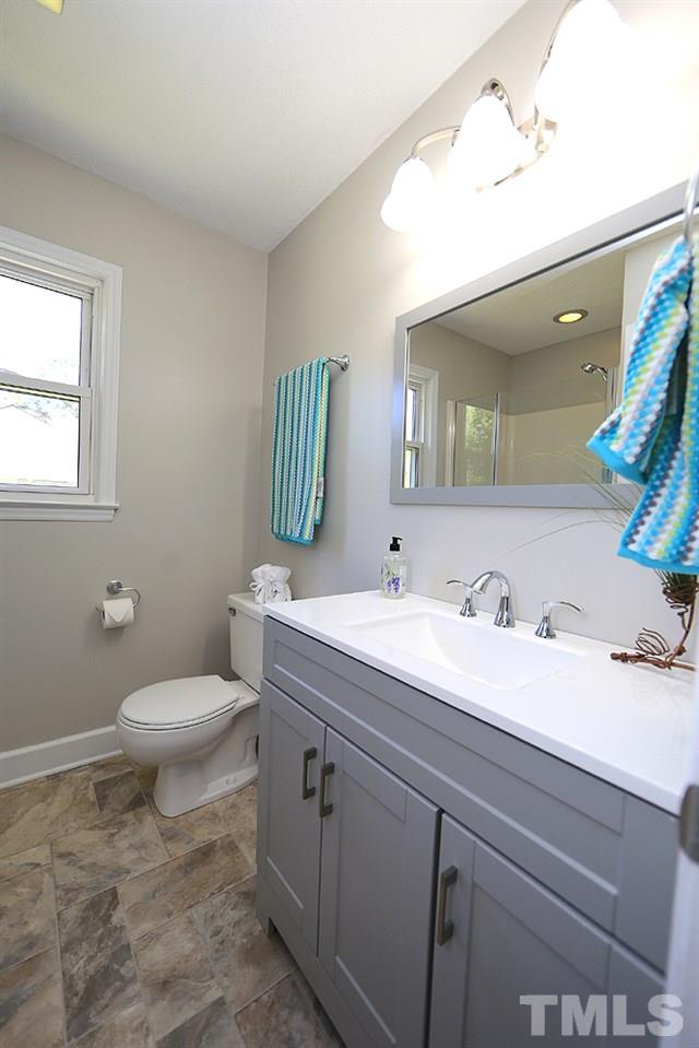 3312 High Gate Road Raleigh, NC 27603 - Photo 12 of 22 a bathroom with a toilet sink and mirror