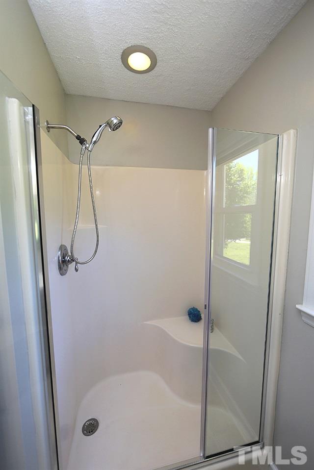 3312 High Gate Road Raleigh, NC 27603 - Photo 13 of 22 a bathroom with a glass shower door