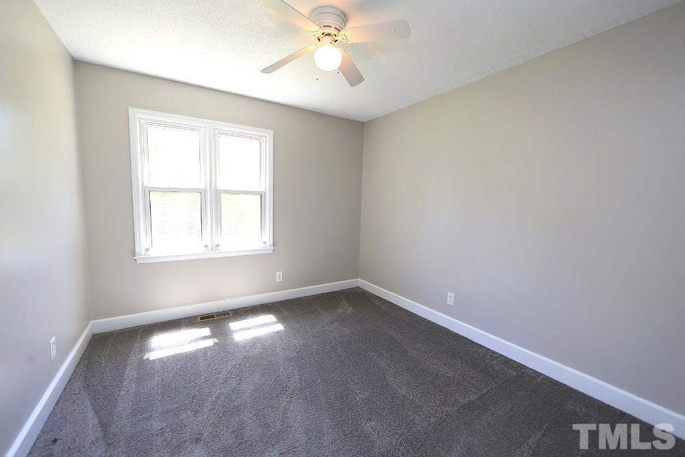 3312 High Gate Road Raleigh, NC 27603 - Photo 16 of 22 an empty room with a window and a fan