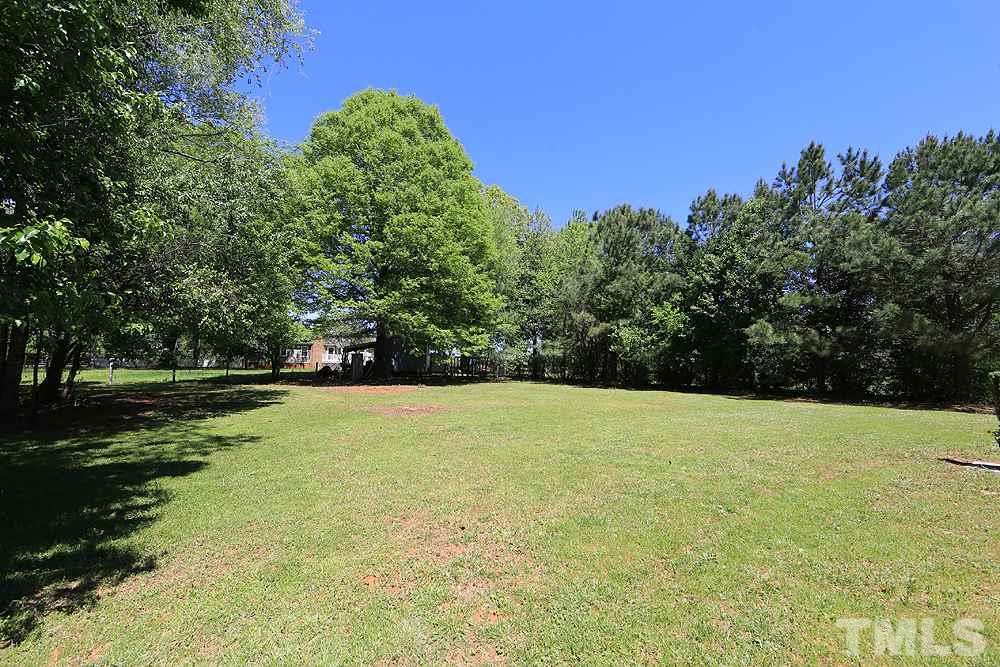 3312 High Gate Road Raleigh, NC 27603 - Photo 20 of 22 a view of a field with trees in the background