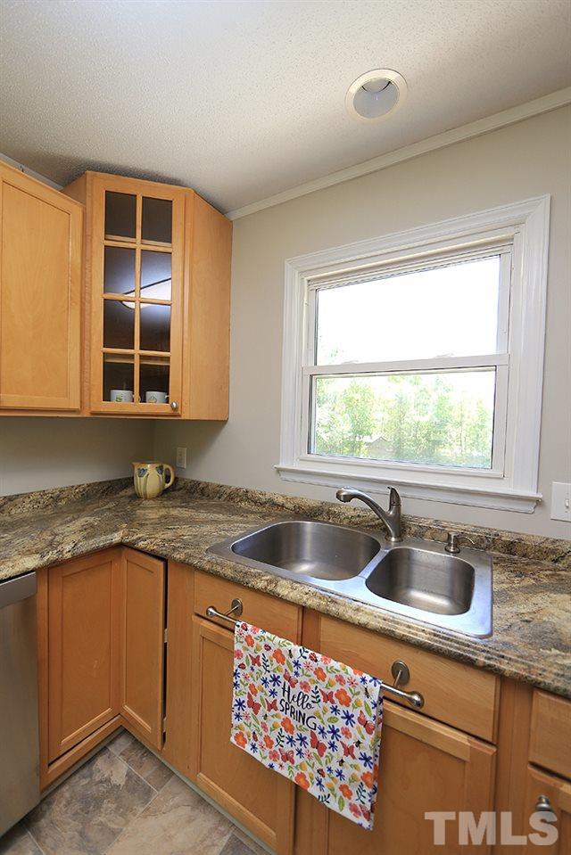 3312 High Gate Road Raleigh, NC 27603 - Photo 4 of 22 a kitchen with granite countertop a sink and a window