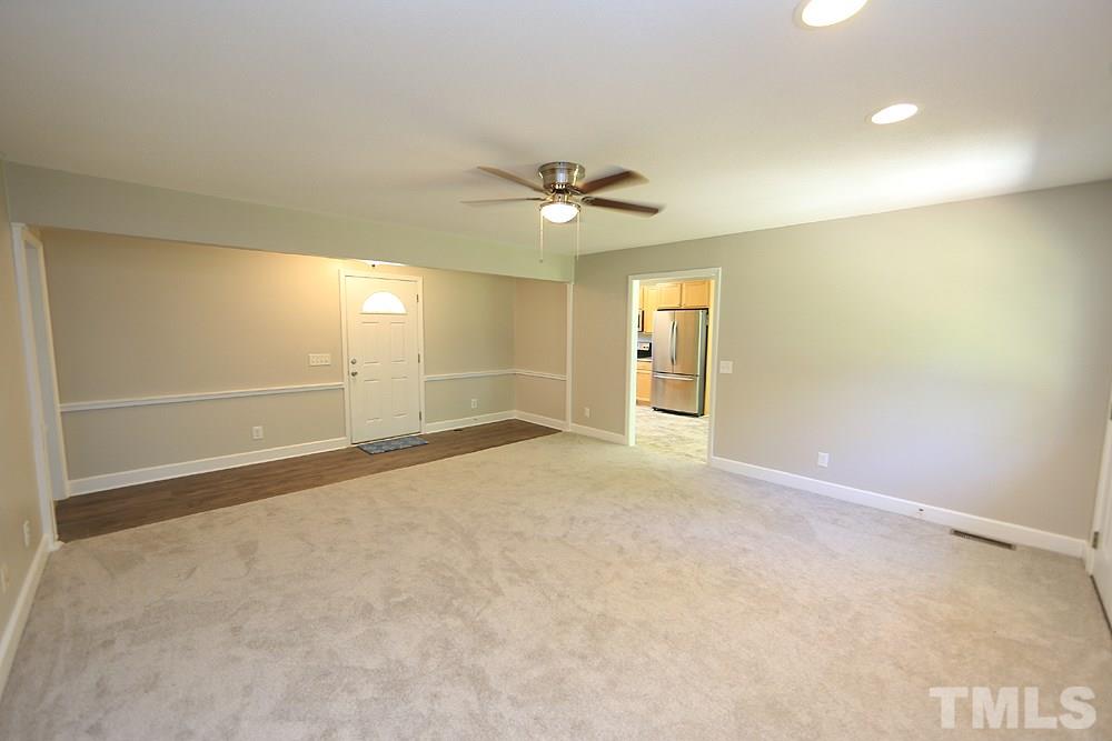 3312 High Gate Road Raleigh, NC 27603 - Photo 5 of 22 en empty room with fan and entryway