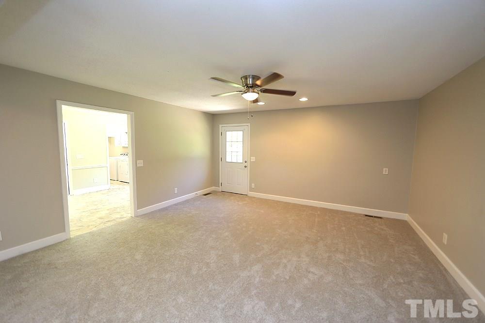 3312 High Gate Road Raleigh, NC 27603 - Photo 8 of 22 an empty room with a window and a ceiling fan