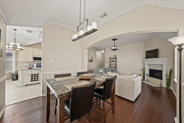 3103 Valley Court Manvel, TX 77578 - Photo 11 of 20 a view of a dining room with furniture wooden floor and a chandelier