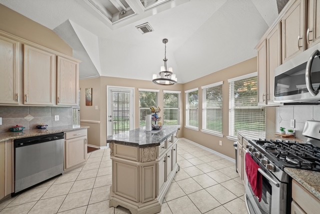 3103 Valley Court Manvel, TX 77578 - Photo 14 of 20 a kitchen with stainless steel appliances a stove sink and cabinets