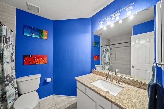 3103 Valley Court Manvel, TX 77578 - Photo 3 of 20 a bathroom with a granite countertop toilet sink and mirror