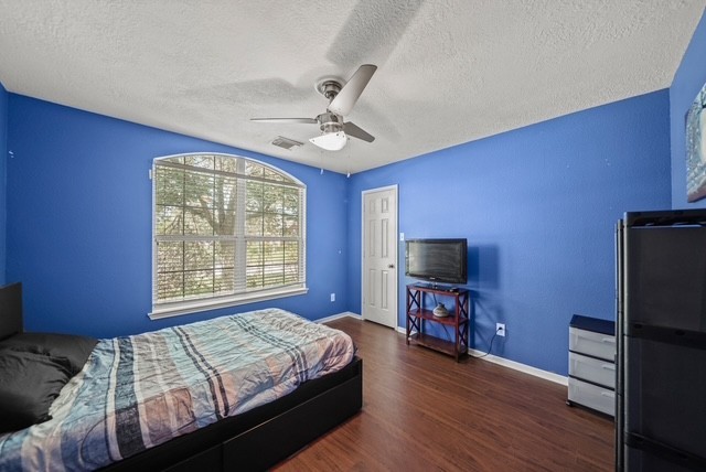 3103 Valley Court Manvel, TX 77578 - Photo 5 of 20 a bedroom with a bed and a flat screen tv