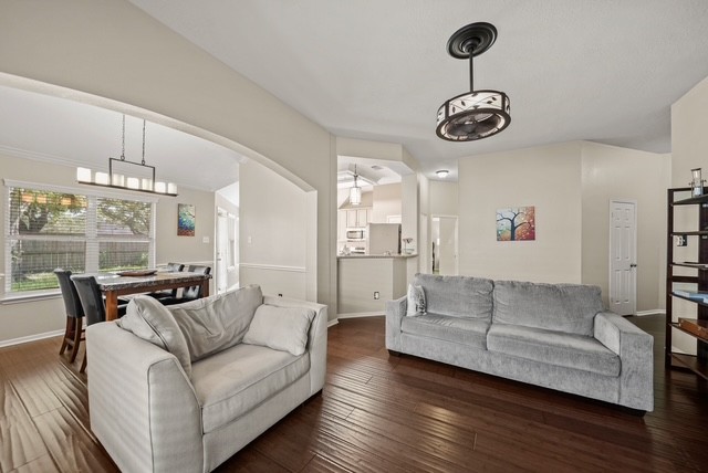 3103 Valley Court Manvel, TX 77578 - Photo 8 of 20 a living room with furniture kitchen view and a chandelier