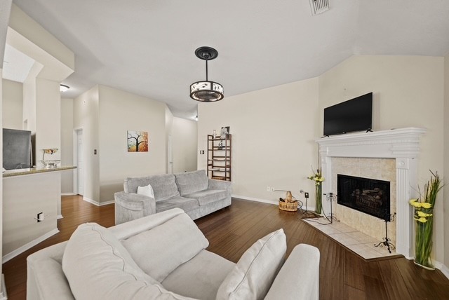 3103 Valley Court Manvel, TX 77578 - Photo 9 of 20 a living room with furniture a flat screen tv and a fireplace