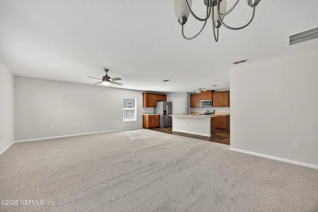 a view of a room with window and wooden floor