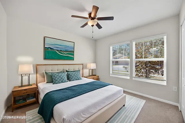 a bedroom with a large bed and a window