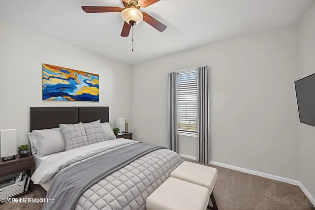 a bedroom with a bed and a painting on the wall