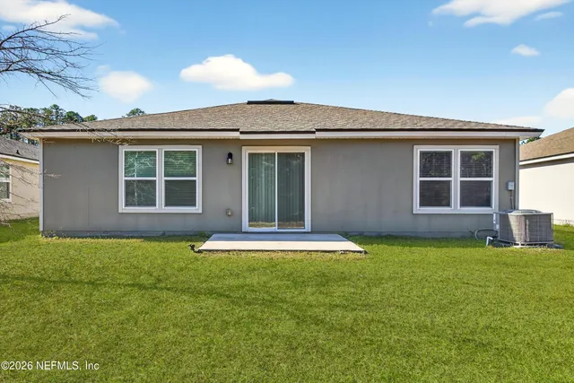 a view of a house with a yard and sitting area