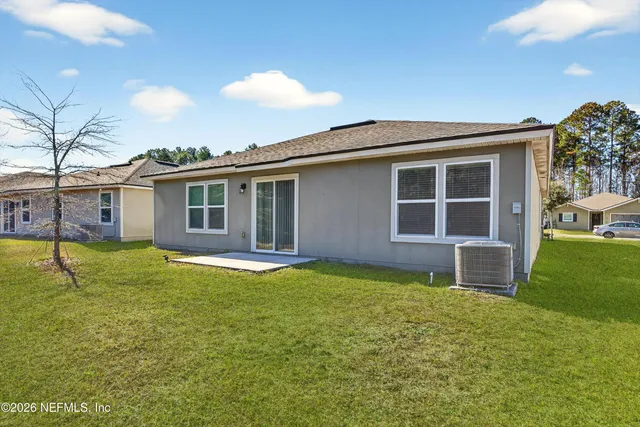 a backyard of a house with table and chairs
