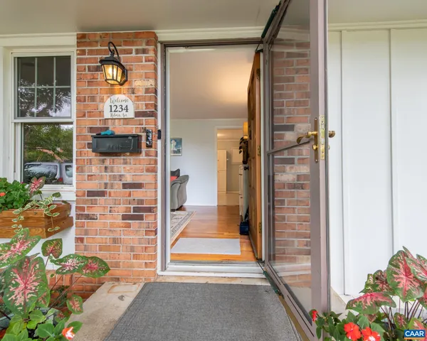 a living room with furniture and painting on the wall