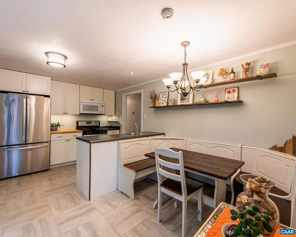 a kitchen with stainless steel appliances granite countertop a sink refrigerator and cabinets