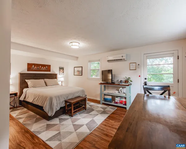 a view of balcony with wooden floor and seating space