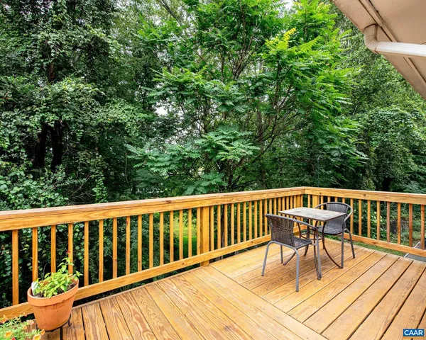 a view of a deck with a table and chairs