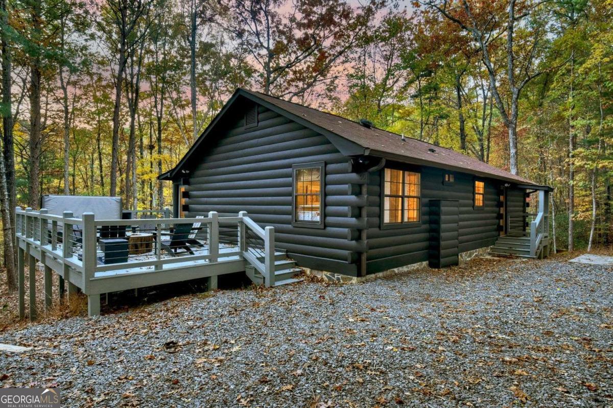 a view of backyard with deck and seating area