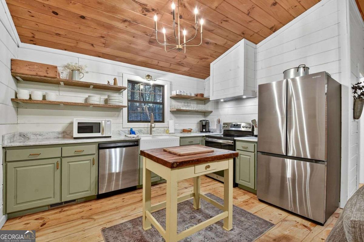 50 Lake View Drive, Unit 26 Blue Ridge, GA 30513 - Photo 12 of 33 a kitchen with stainless steel appliances granite countertop a sink stove and refrigerator