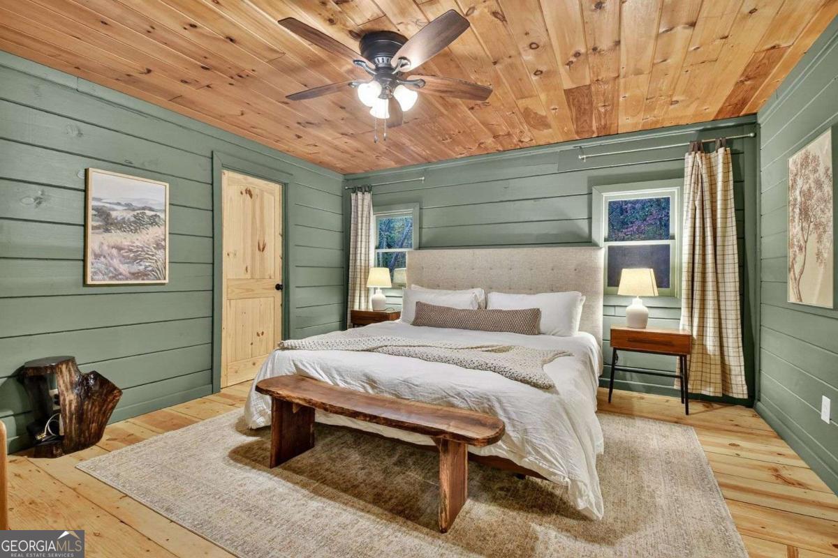 50 Lake View Drive, Unit 26 Blue Ridge, GA 30513 - Photo 15 of 33 a bedroom with a bed and a chandelier