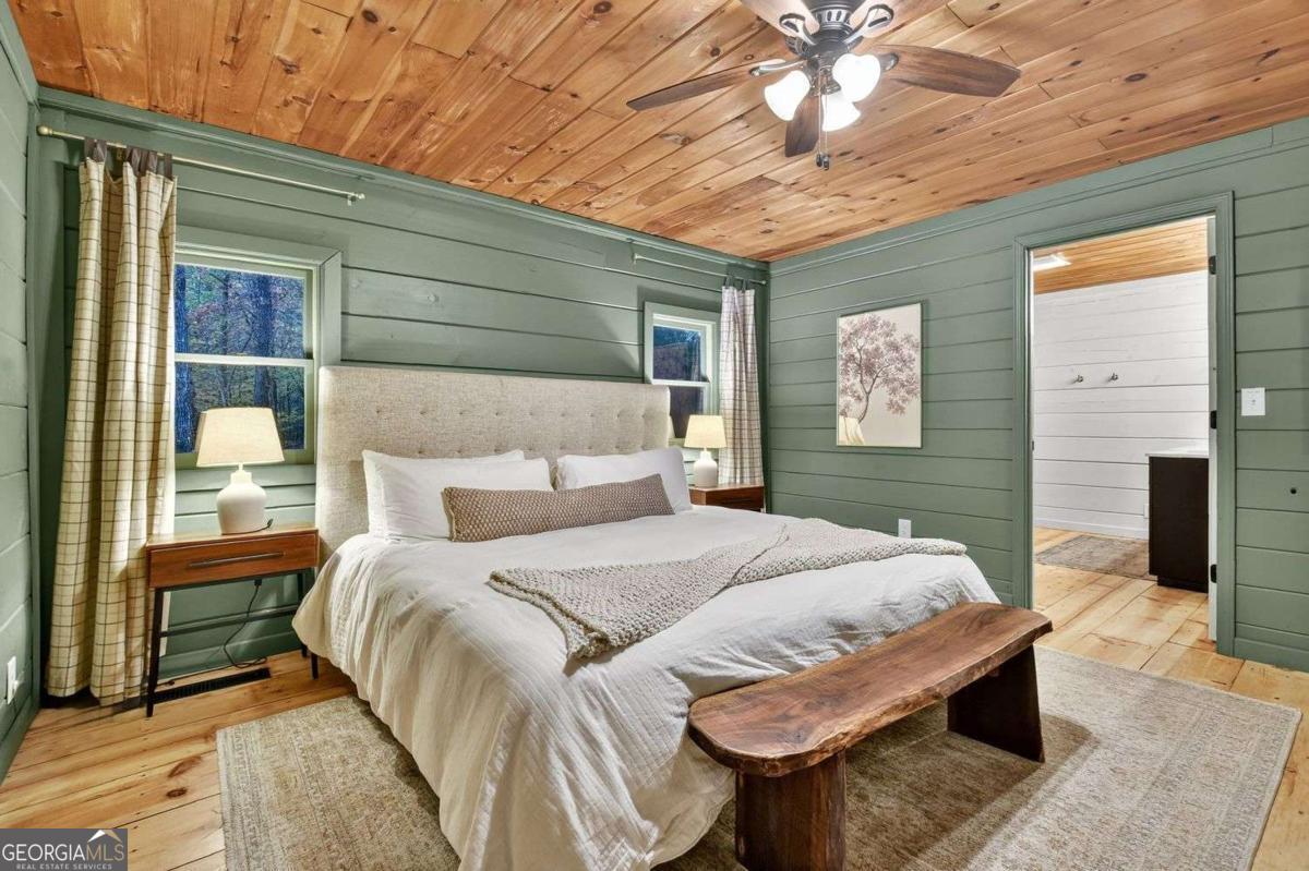 50 Lake View Drive, Unit 26 Blue Ridge, GA 30513 - Photo 16 of 33 a bedroom with a bed and a chandelier