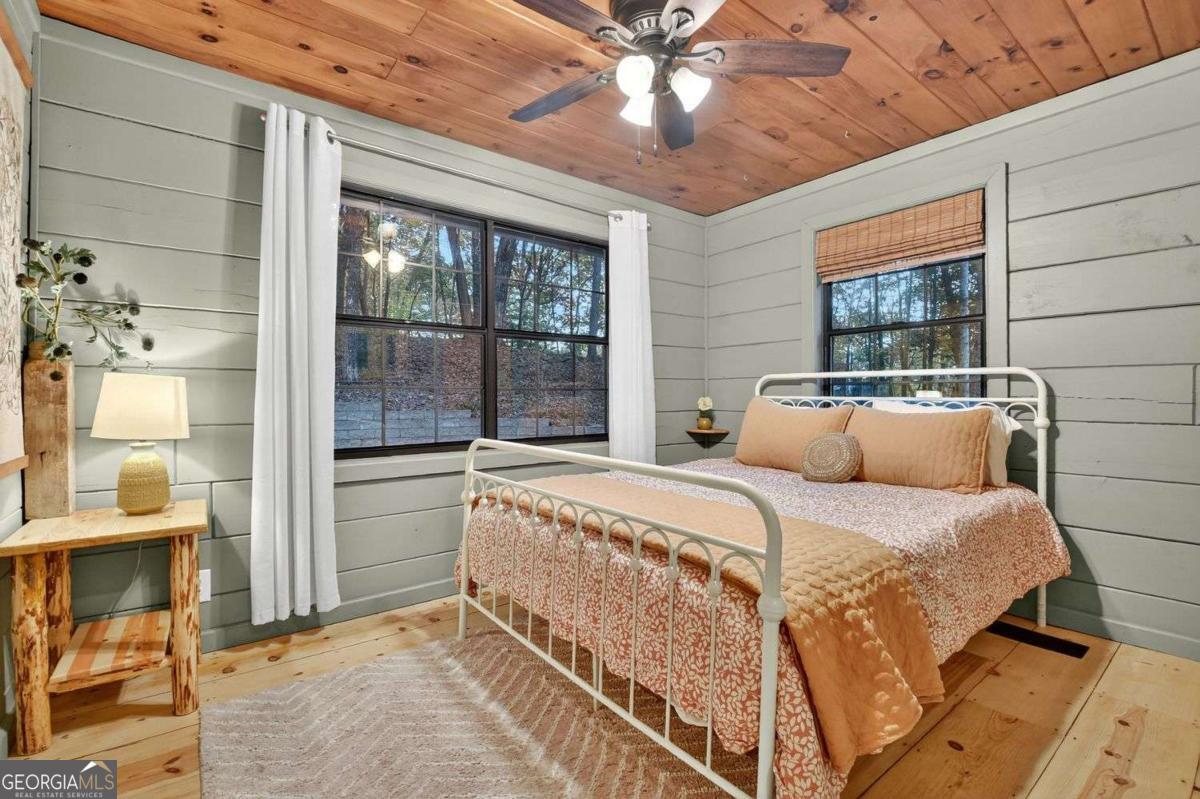 50 Lake View Drive, Unit 26 Blue Ridge, GA 30513 - Photo 20 of 33 a bed sitting in a bedroom next to a window