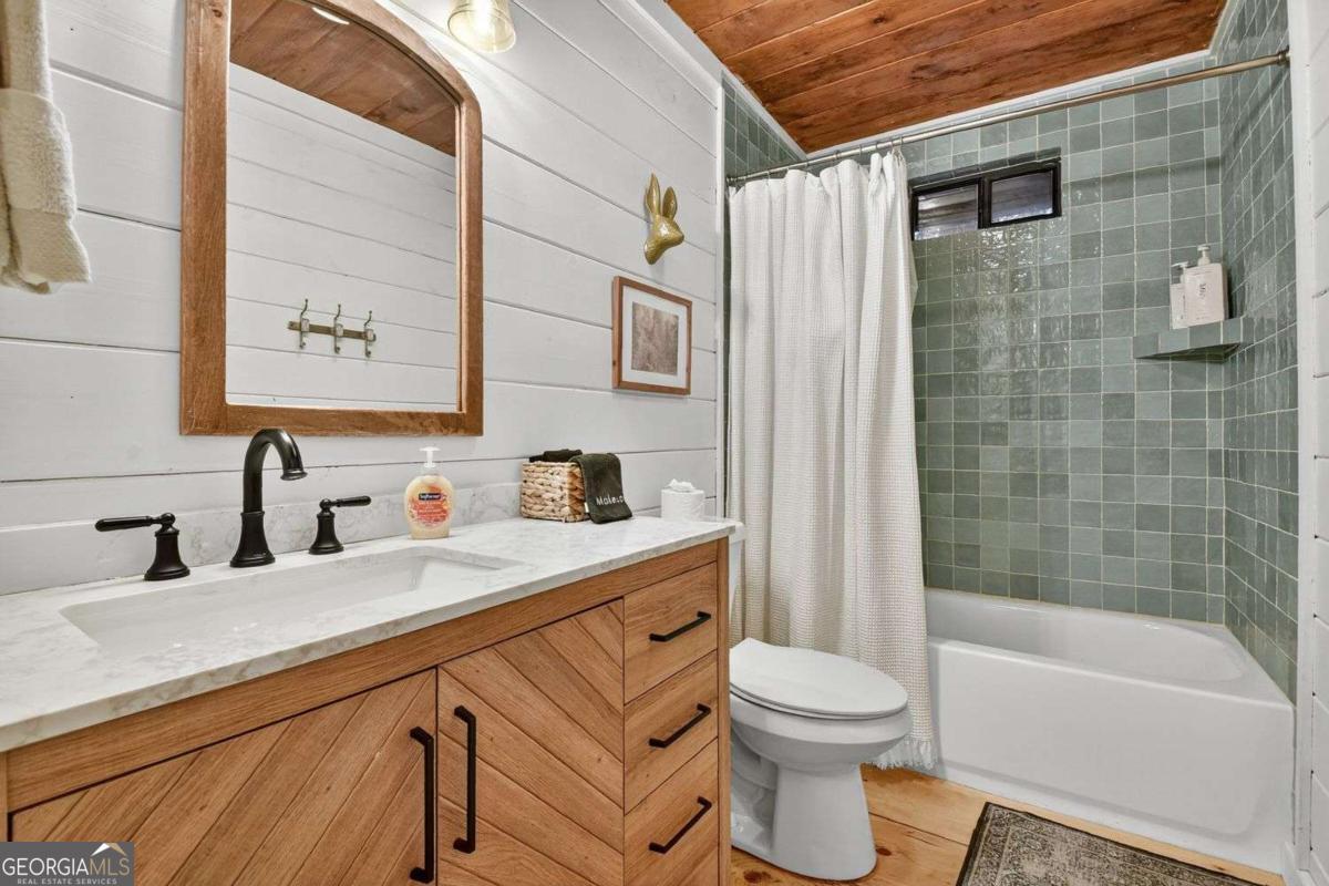 50 Lake View Drive, Unit 26 Blue Ridge, GA 30513 - Photo 21 of 33 a bathroom with a sink a toilet and shower