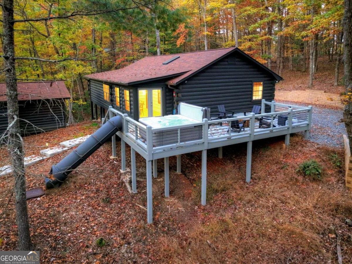 50 Lake View Drive, Unit 26 Blue Ridge, GA 30513 - Photo 27 of 33 a backyard of a house with wooden deck table and chairs