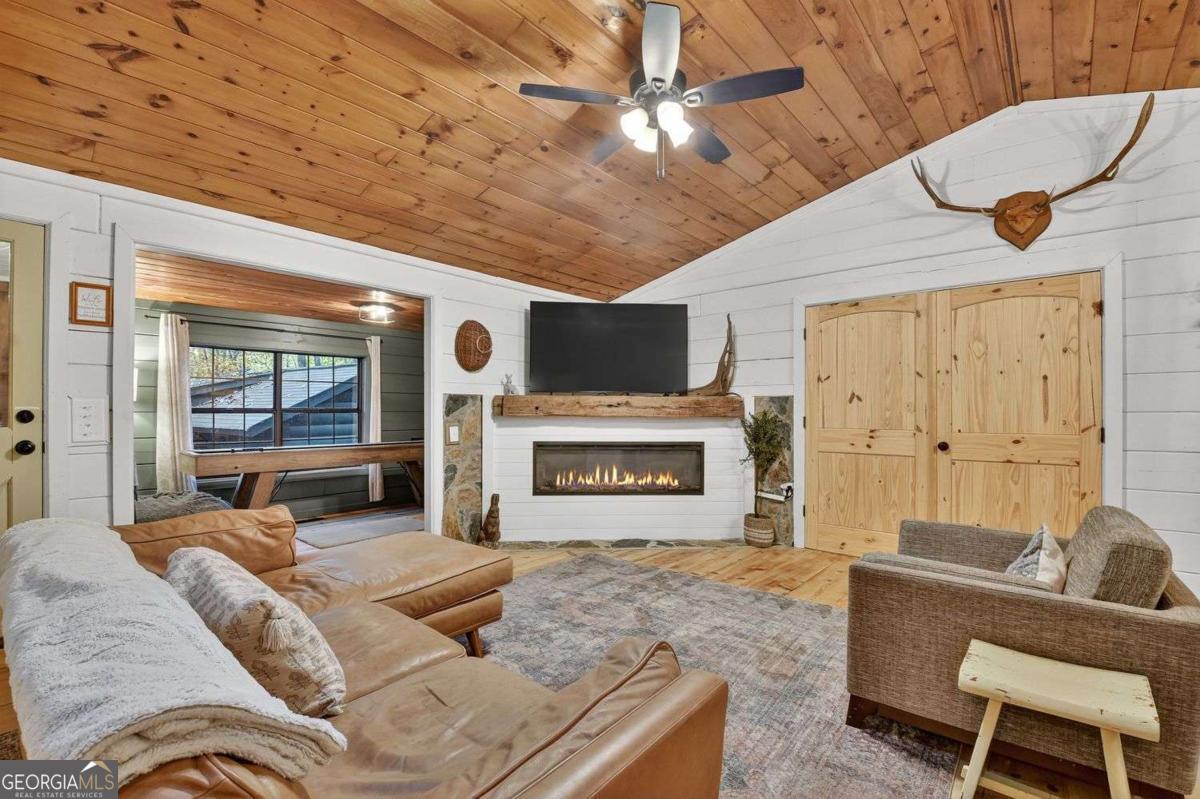 50 Lake View Drive, Unit 26 Blue Ridge, GA 30513 - Photo 9 of 33 a living room with furniture a flat screen tv and a fireplace