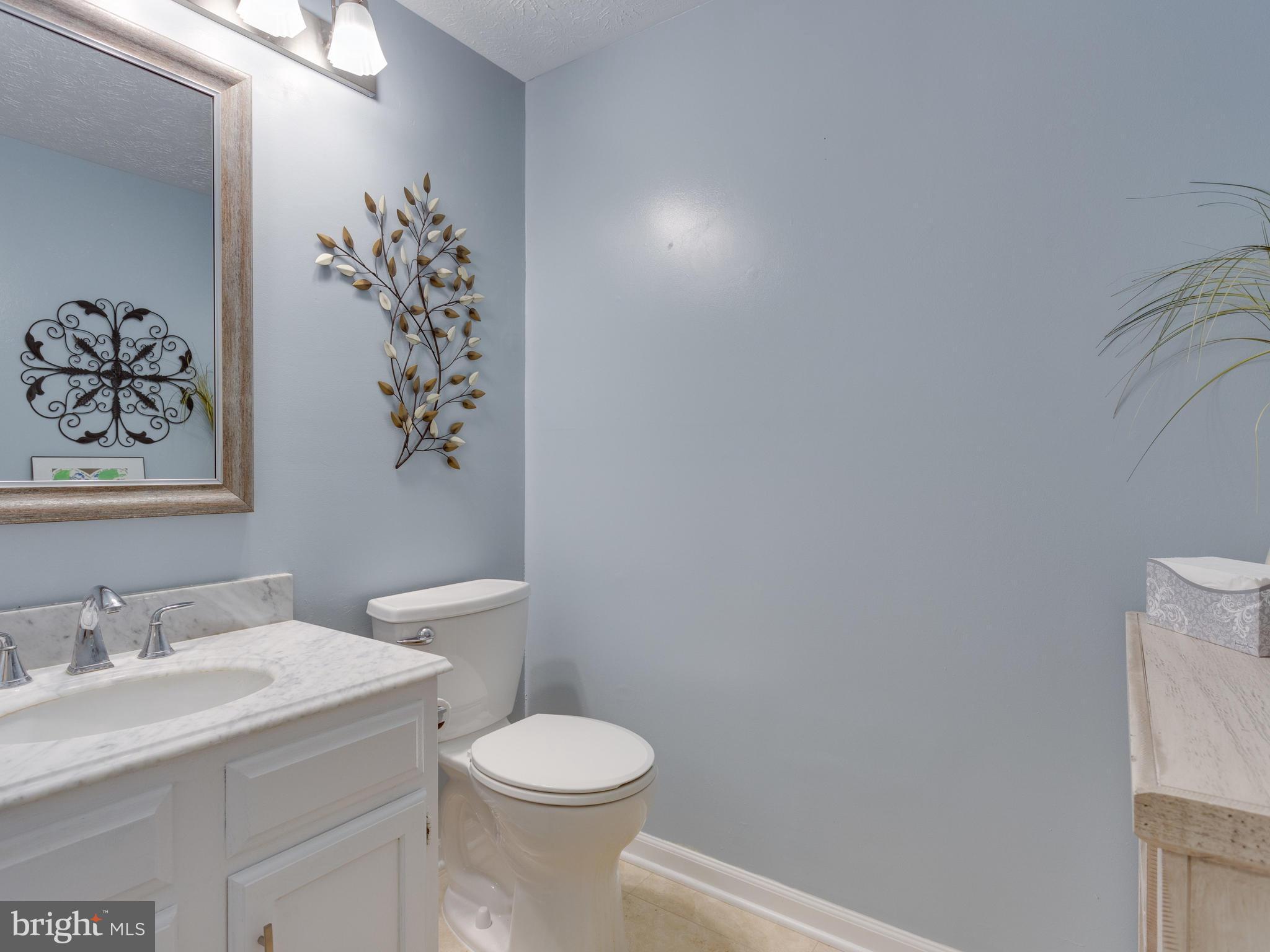 7817 Roundabout Way Springfield, VA 22153 - Photo 12 of 30 a bathroom with a granite countertop sink and a toilet