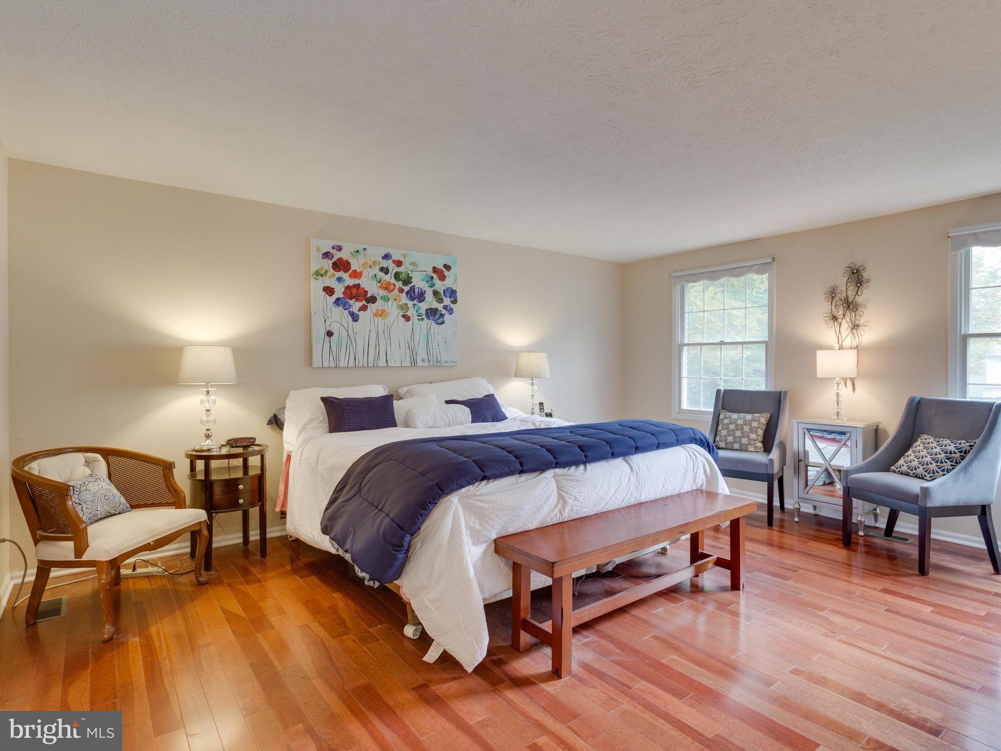 7817 Roundabout Way Springfield, VA 22153 - Photo 13 of 30 a bedroom with a bed and wooden floor