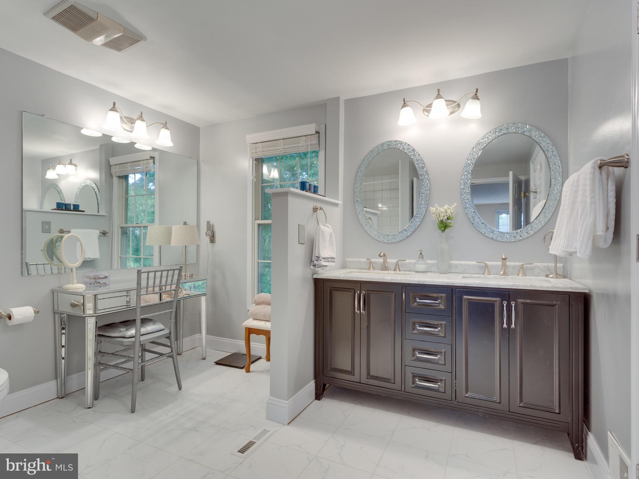 7817 Roundabout Way Springfield, VA 22153 - Photo 14 of 30 a bathroom with a granite countertop sink and a mirror