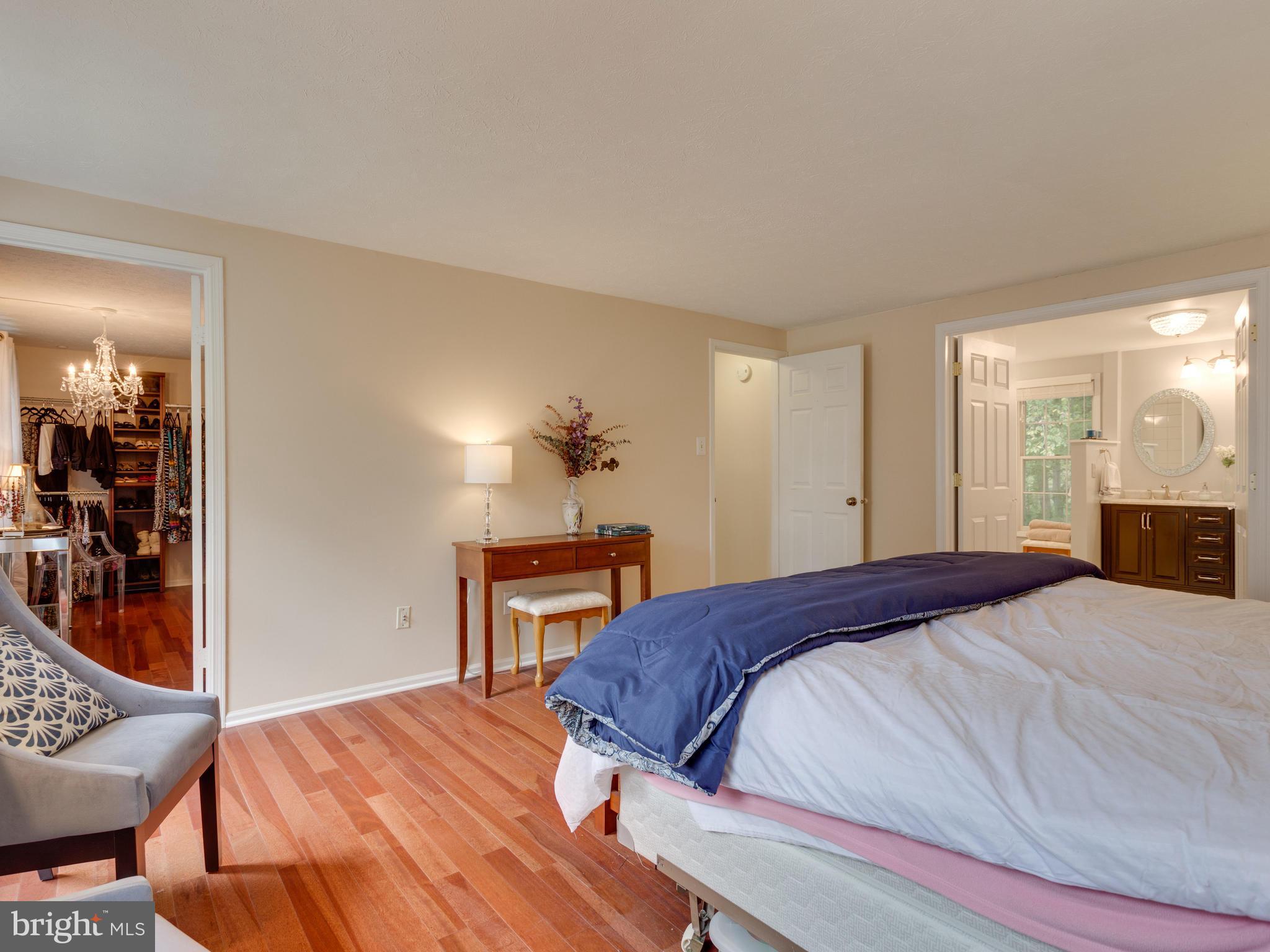 7817 Roundabout Way Springfield, VA 22153 - Photo 15 of 30 a bedroom with a bed and wooden floor