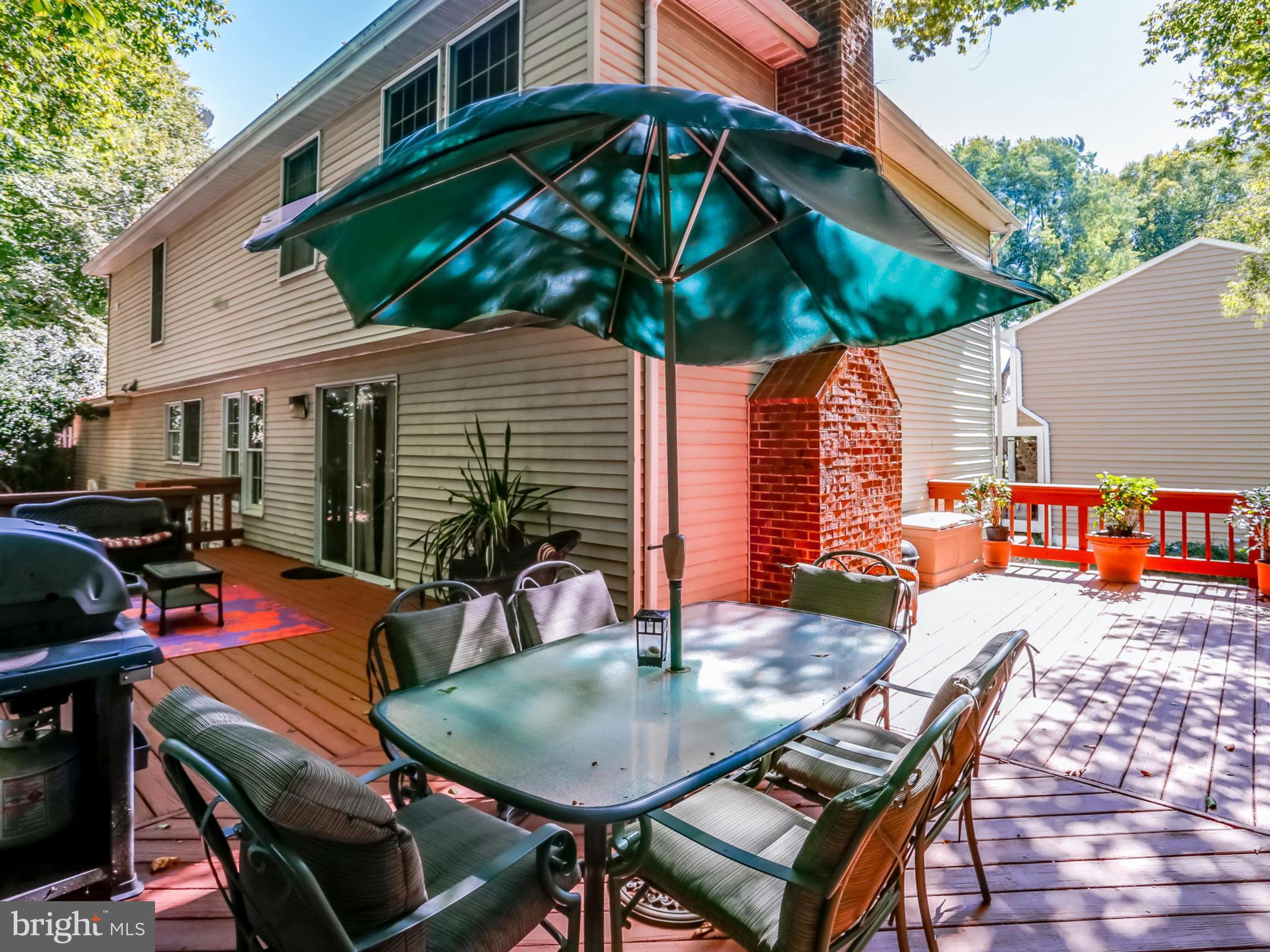 7817 Roundabout Way Springfield, VA 22153 - Photo 27 of 30 a backyard of a house with wooden floor barbeque oven and outdoor seating