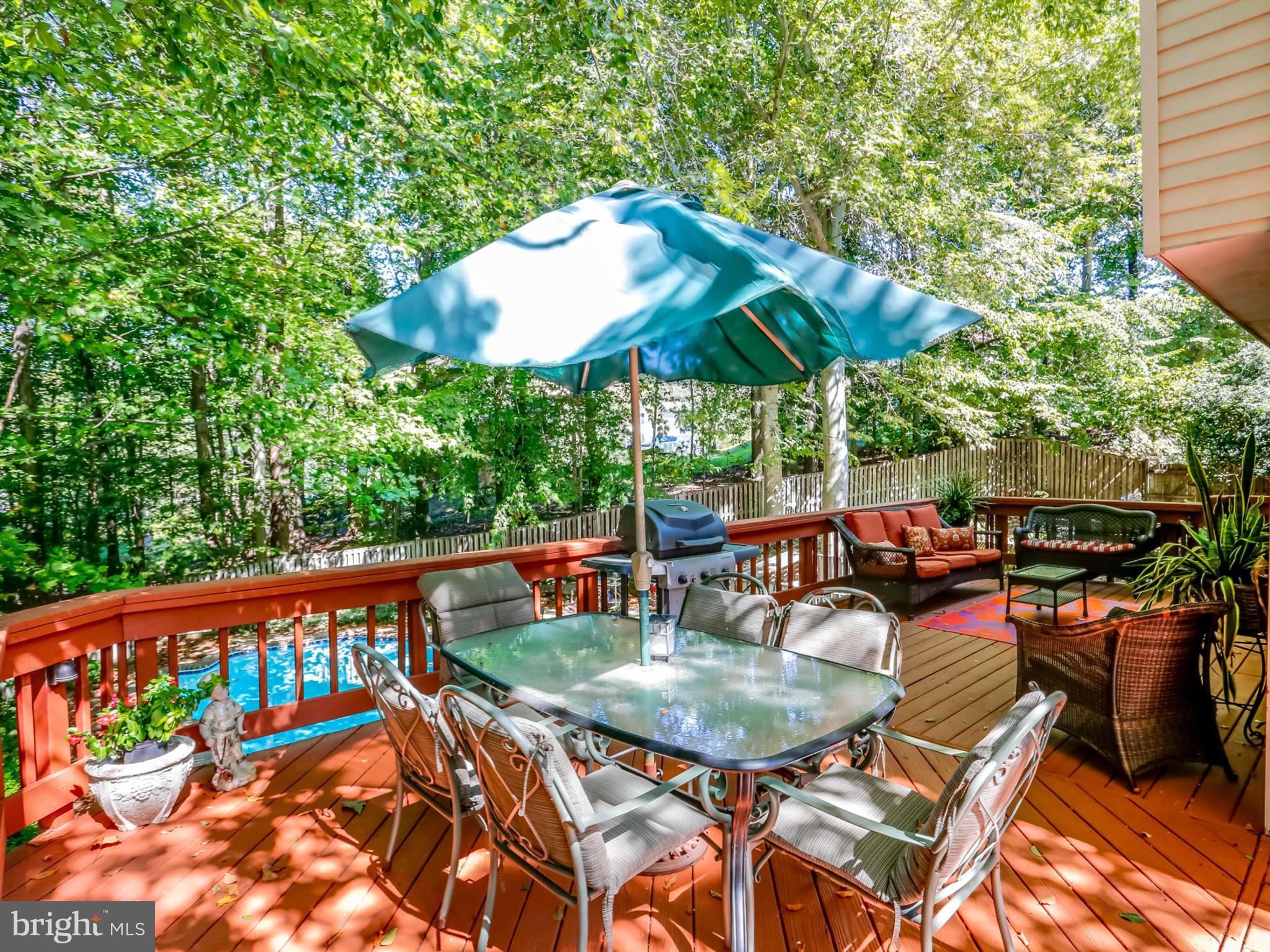 7817 Roundabout Way Springfield, VA 22153 - Photo 28 of 30 a view of a patio with a table and chairs under an umbrella