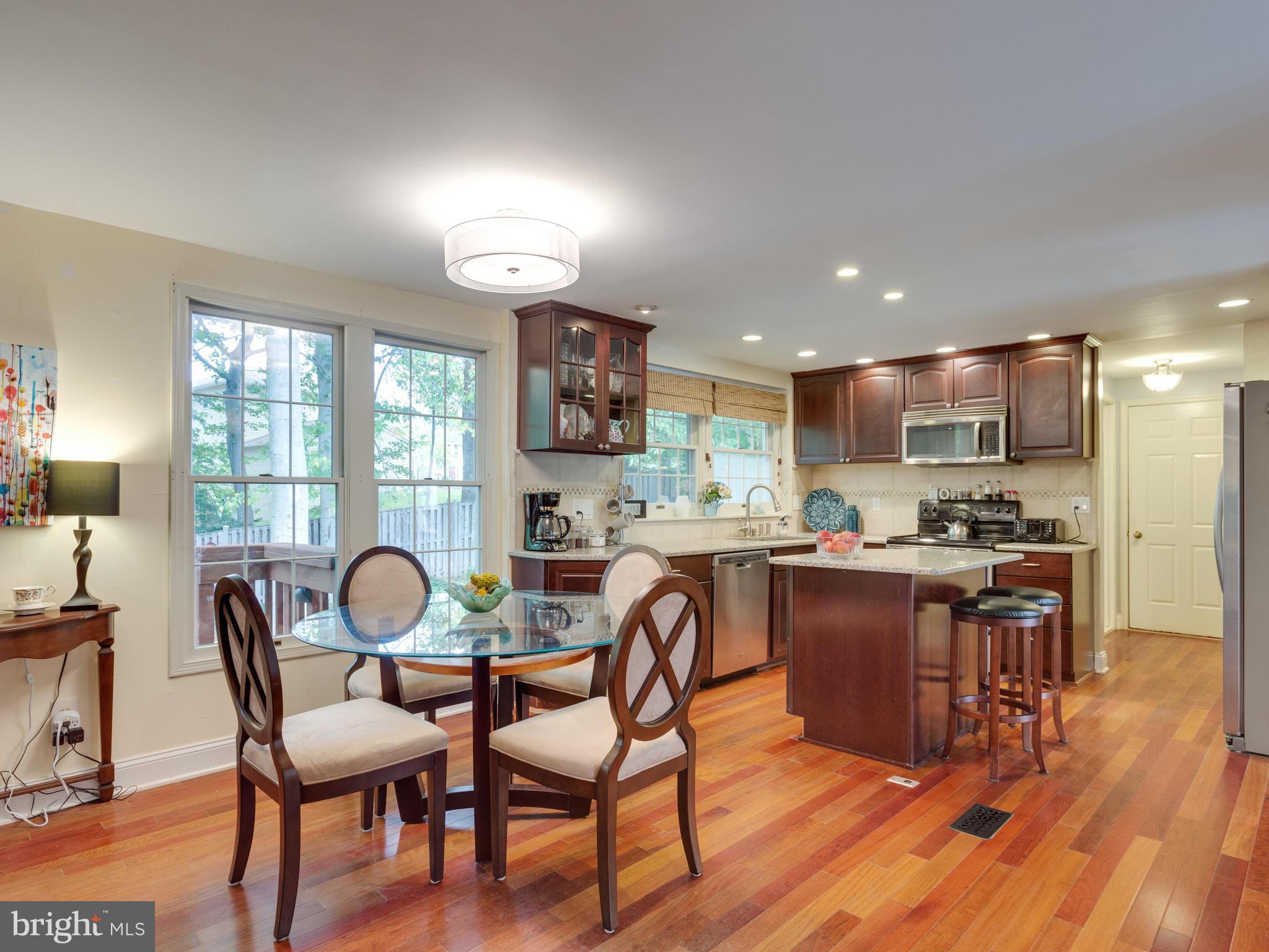 7817 Roundabout Way Springfield, VA 22153 - Photo 6 of 30 a view of a dining room with furniture a rug and wooden floor
