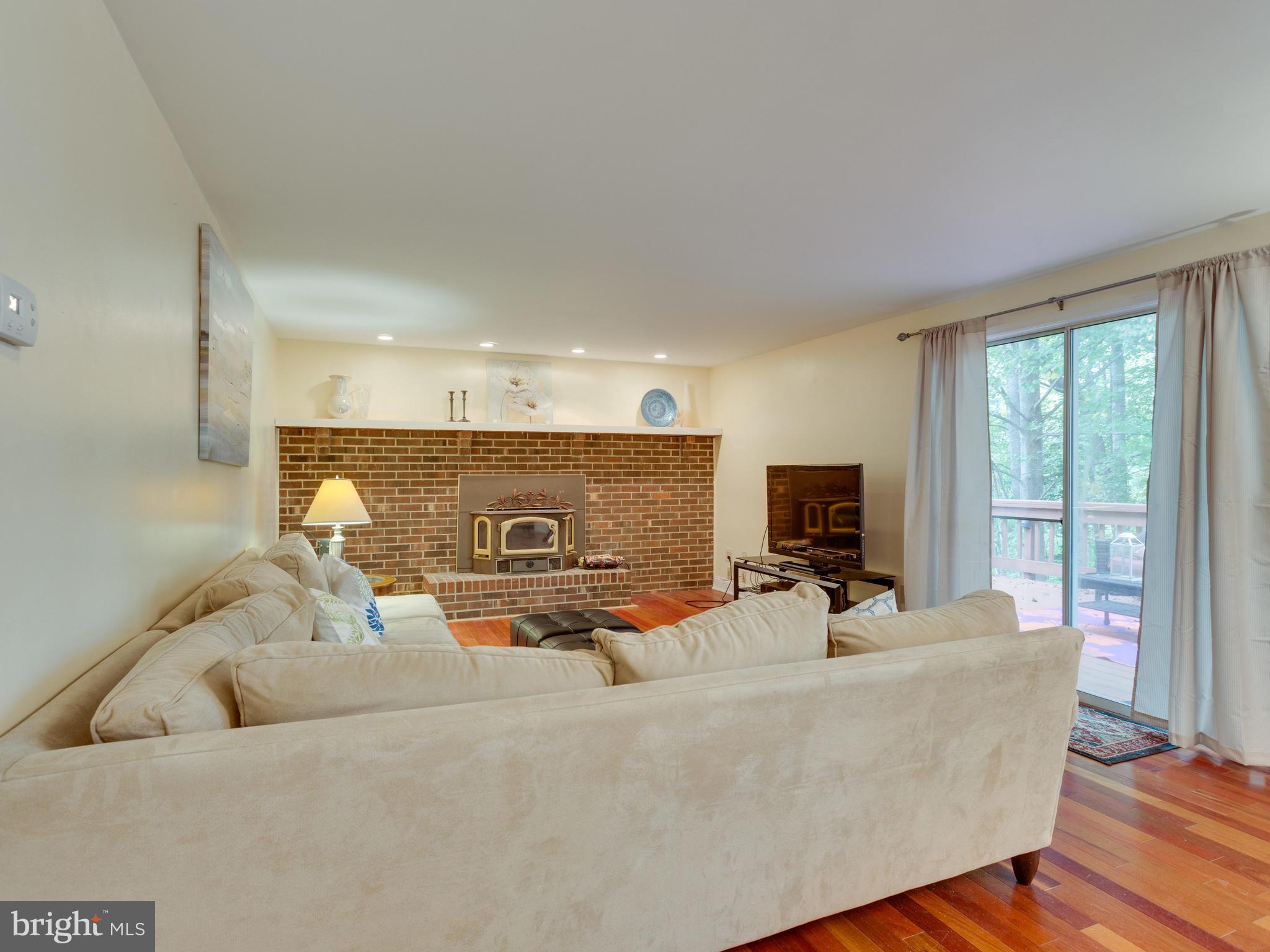 7817 Roundabout Way Springfield, VA 22153 - Photo 9 of 30 a living room with furniture and a flat screen tv