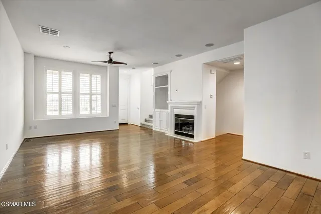 wooden floor in an empty room with a fireplace